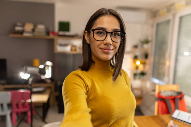 istock Beautiful young woman taking selfie at home 1999834536