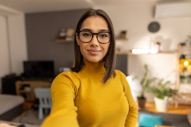 istock Beautiful young woman taking selfie at home 1999834563