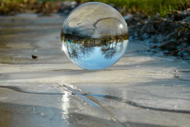 istock Crystal ball on frozen field 1999839205