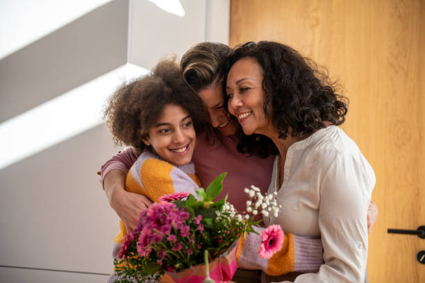 istock Mother's day, three generation female family hug 1999853177