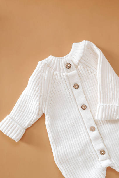 istock Jumpsuits for newborns on a beige background. Spring clothes for children 1999855261