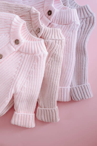 istock Multicolor Jumpsuits for newborns on a pink background 1999862030
