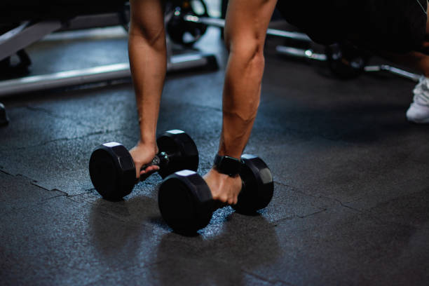 istock Exercise with dumbbells Lift weights to build strong arm muscles, an activity for good physical health. 1999863104
