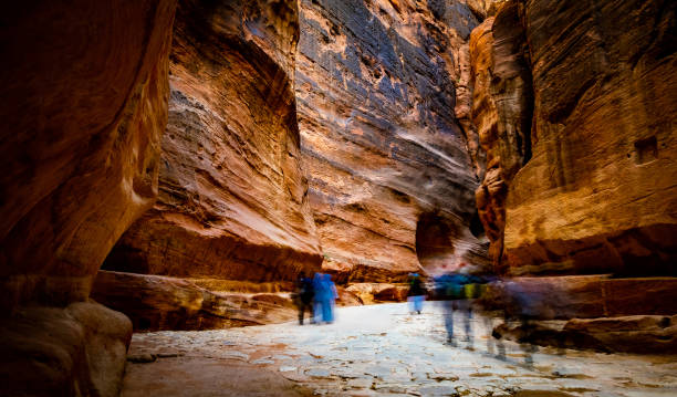 istock Group of tourists between rocks, Jordan 1999881687