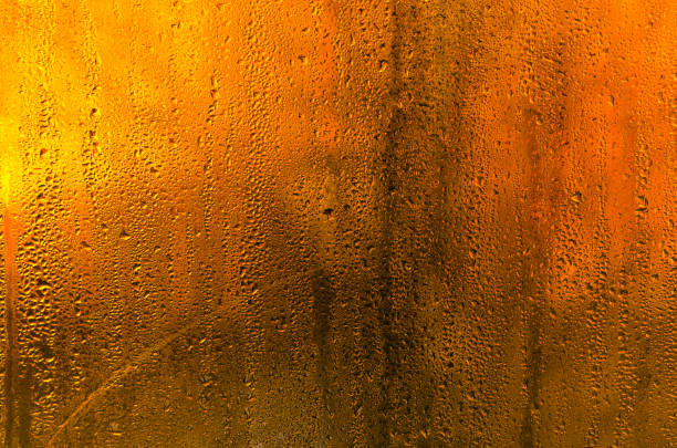 istock wet glass background. drops on the glass. 1999904144