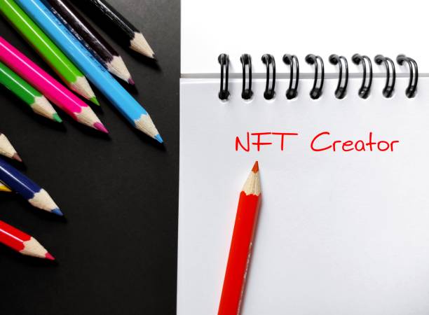 istock Color pencils on notebook with handwritten text NFT CREATOR, means artist who create their own crypto art and sell it on various digital marketplace and grow earning from intellectual property 1999905172
