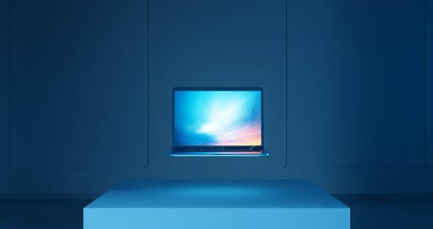 istock A dark evening setting with a laptop resting on a stand within a room. 1999918927