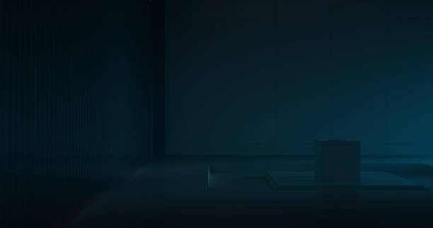 Cast in shadows, a thin, closed laptop rests on a pedestal in a dark room at night, its minimalist design subtly hinting at its presence with a faint, gentle radiance.