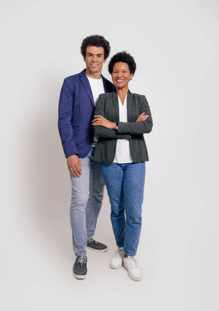 istock Full length of business partners smiling and posing confidently while standing on white background 1999928564