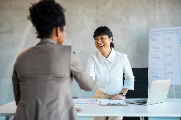 istock Business people shaking hands in office 1999929039