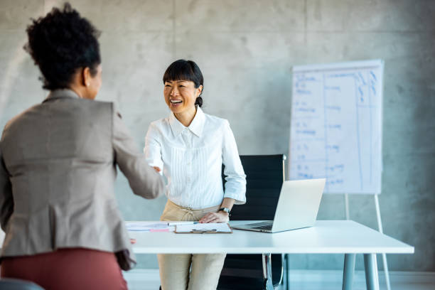 istock Young business people meeting office handshake hand shake shaking hands teamwork group contract agreement 1999929040