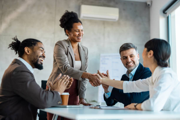 istock Diverse business partners shaking hands starting collaboration at group negotiations 1999929117