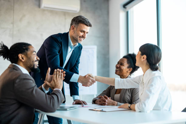 istock Trainer shake hands with participant before starting education meeting 1999929127