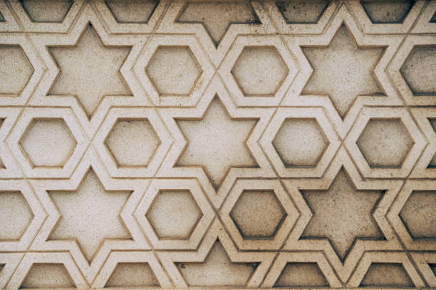 Fragment of an ornament on a stone, decoration for a stone wall or fence.