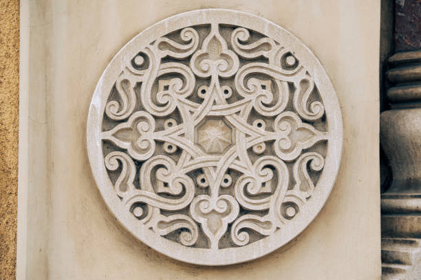 Fragment of an ornament on a stone, decoration for a stone wall or fence.