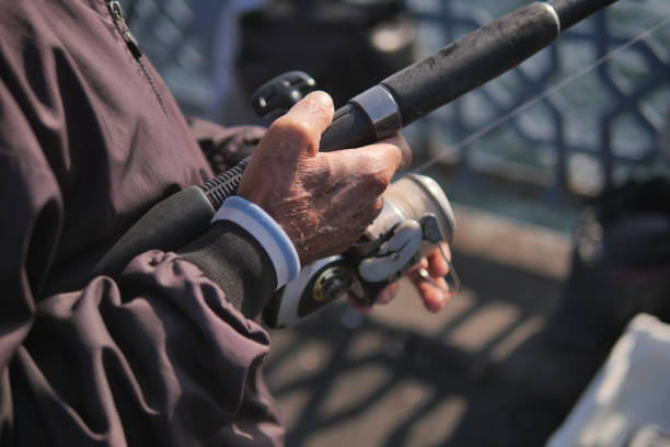 Fisherman with rod, spinning reel