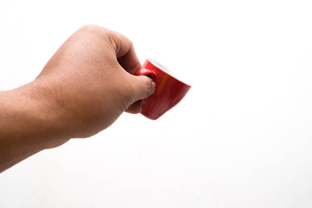 istock man's hand holding a red cup isolated on a white background 1999940876