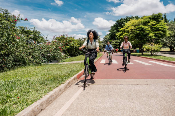 istock Coworkers riding a bicycle at public park 1999952712