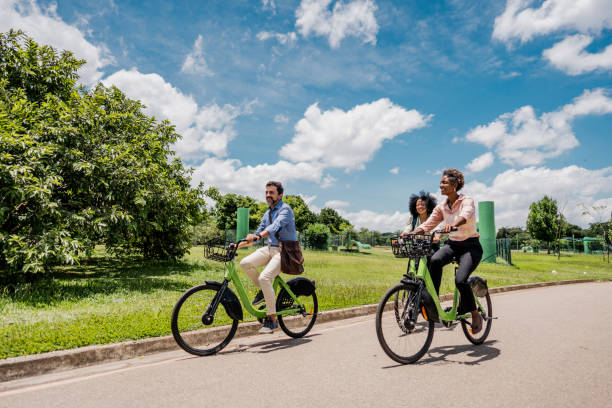 Coworkers riding a bicycle at public park