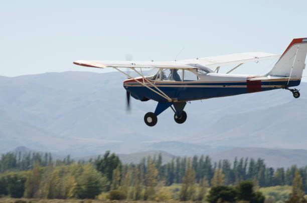 istock blue and white propeller plane flying close to landing 1999966636