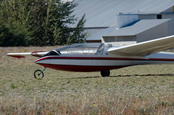 ultralight glider plane on the runway, white and red glider with wheels about to be towed