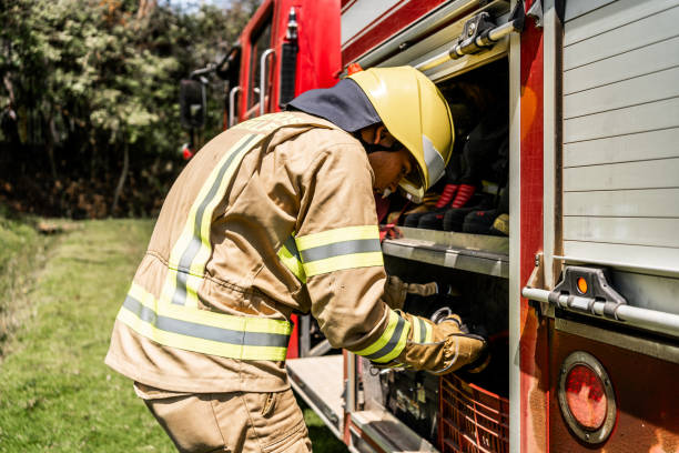 istock Fireman picking up equipments on fire truck 1999982835