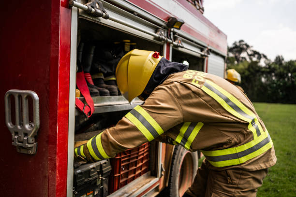 istock Fireman picking up equipments on fire truck 1999983896
