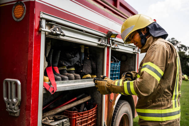 istock Fireman picking up equipments on fire truck 1999983906