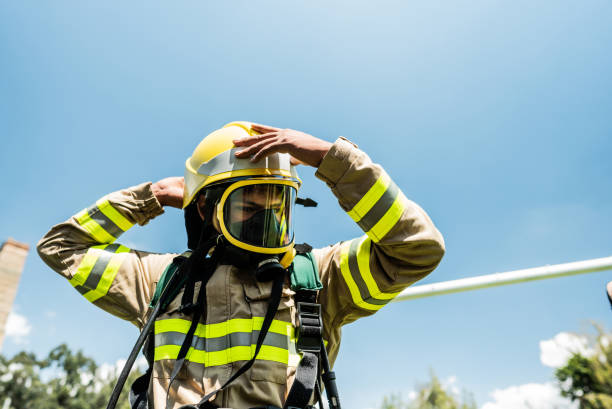 Fireman putting on oxygen mask outdoors
