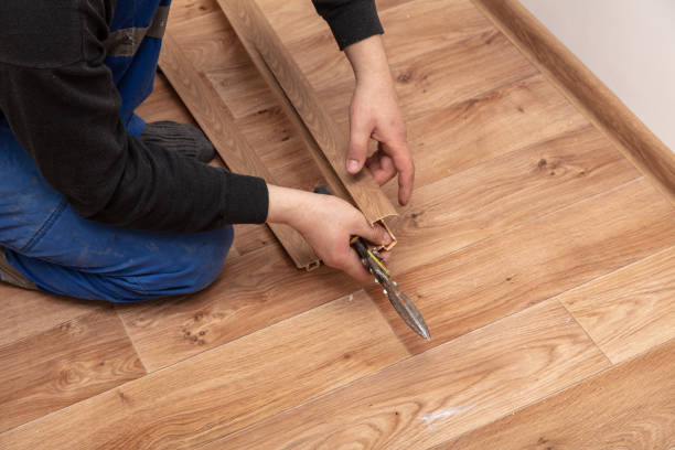istock A worker installs a skirting board on the floor in a room 1999986016