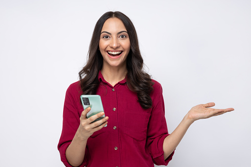 Portrait of young cheerful amazed girl wearing shirt isolated over white background