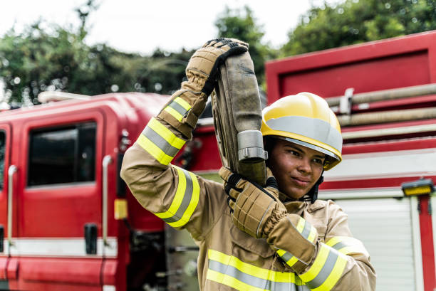 istock Young fireman carrying a fire hose outdoors 2000004389