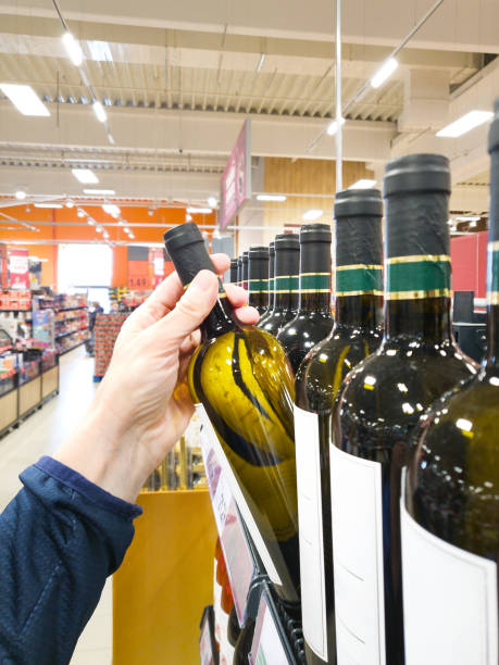 istock Bottle of white wine on hand in shop 2000015380