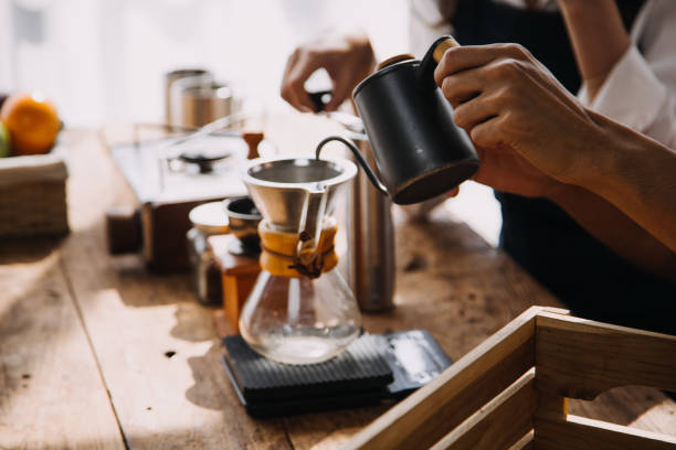 istock Professional barista preparing coffee using chemex pour over coffee maker and drip kettle. Alternative ways of brewing coffee. Coffee shop concept. 2000054772