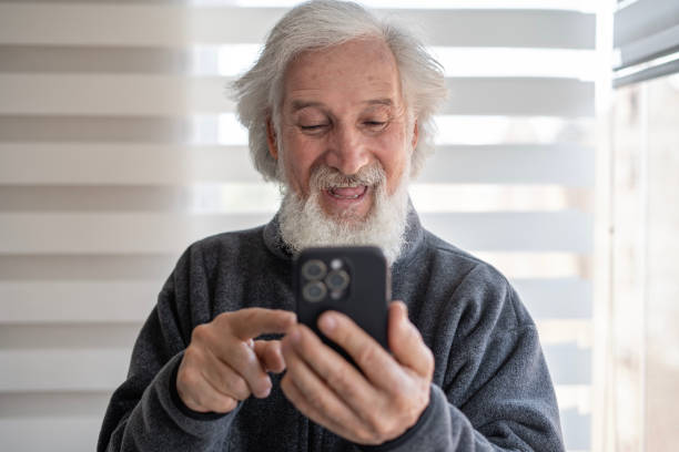 istock Portrait of an elderly man using a smartphone at home. 2000079146
