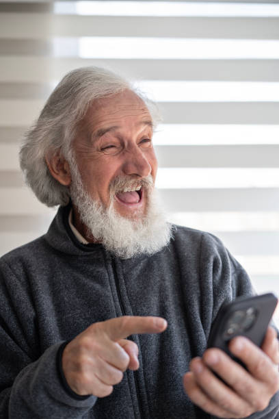 istock Portrait of an elderly man using a smartphone at home. 2000079683
