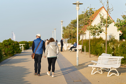 Kühlungsborn, Germany – May 26, 2023: Couple walking on the beach promenade of Kühlungsborn on the German Baltic Sea coast
