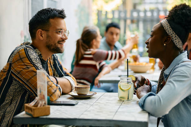 istock Happy man talking to his black girlfriend in a cafe. 2000113400