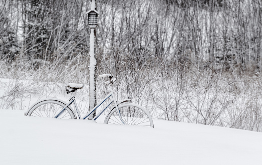Old bicycle and deep snow during Winter