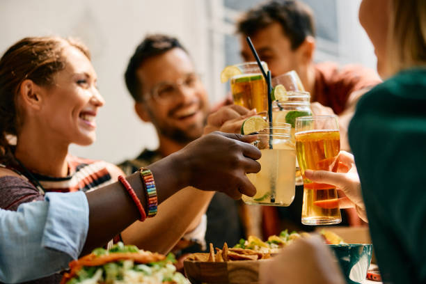 istock Close up of friends toasting while having lunch in a restaurant. 2000120430