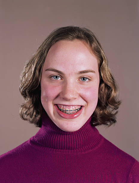 teenage girl (14-16) with braces on teeth, high section, portrait - pfas bildbanksfoton och bilder