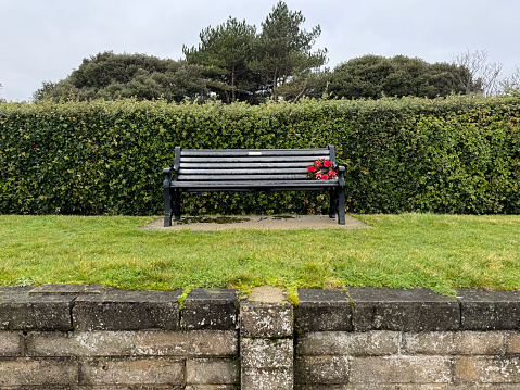 Memorial flowers left on a park bench in Lowestoft, Suffolk