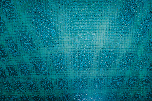 Mosaic bottom of underwater pool. Photo of swimming pool background. Sport, vacation and relax concept. Summer background. Texture of water surface. Top view. Under water in swimming pool. Down view.