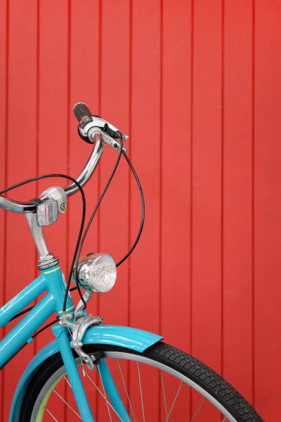 istock Blue vintage bicycle on red wooden wall background 2000155254