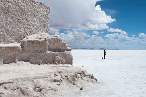 A local playing football (soccer) in a slid salt lake, Salar de Uyuini, the world's largest salt flat, Bolivian altiplano