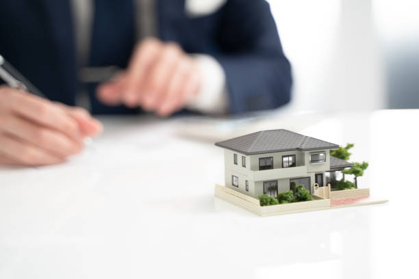 istock Hand of a businessman writing a real estate contract 2000201752