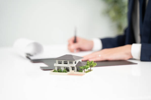 istock Hand of a businessman writing a real estate contract 2000202288