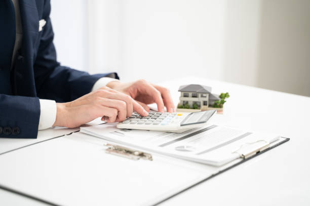 istock Hand of a businessman writing a real estate contract 2000202299