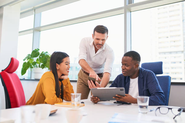 istock Startup colleagues discussing business project on tablet and a phone at office 2000205910