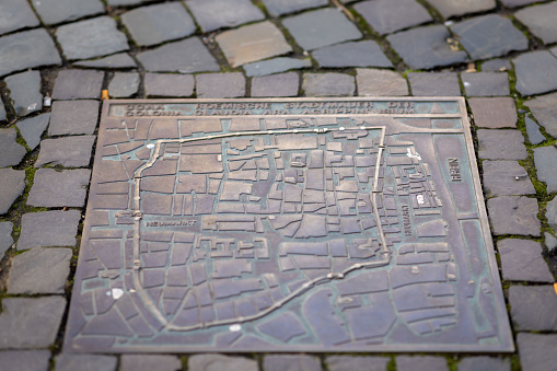 Grunge map of Germany with its flag printed within its border on an old paper.